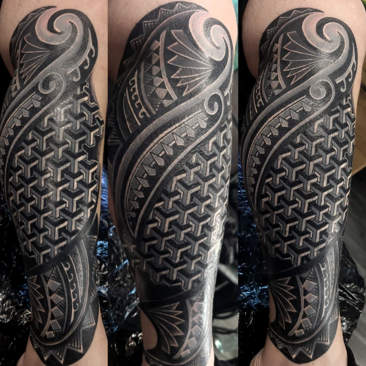Intricate black and grey tattoo sleeve featuring geometric patterns, bold lines, and swirling tribal designs, covering the entire lower leg from calf to ankle in three different views.