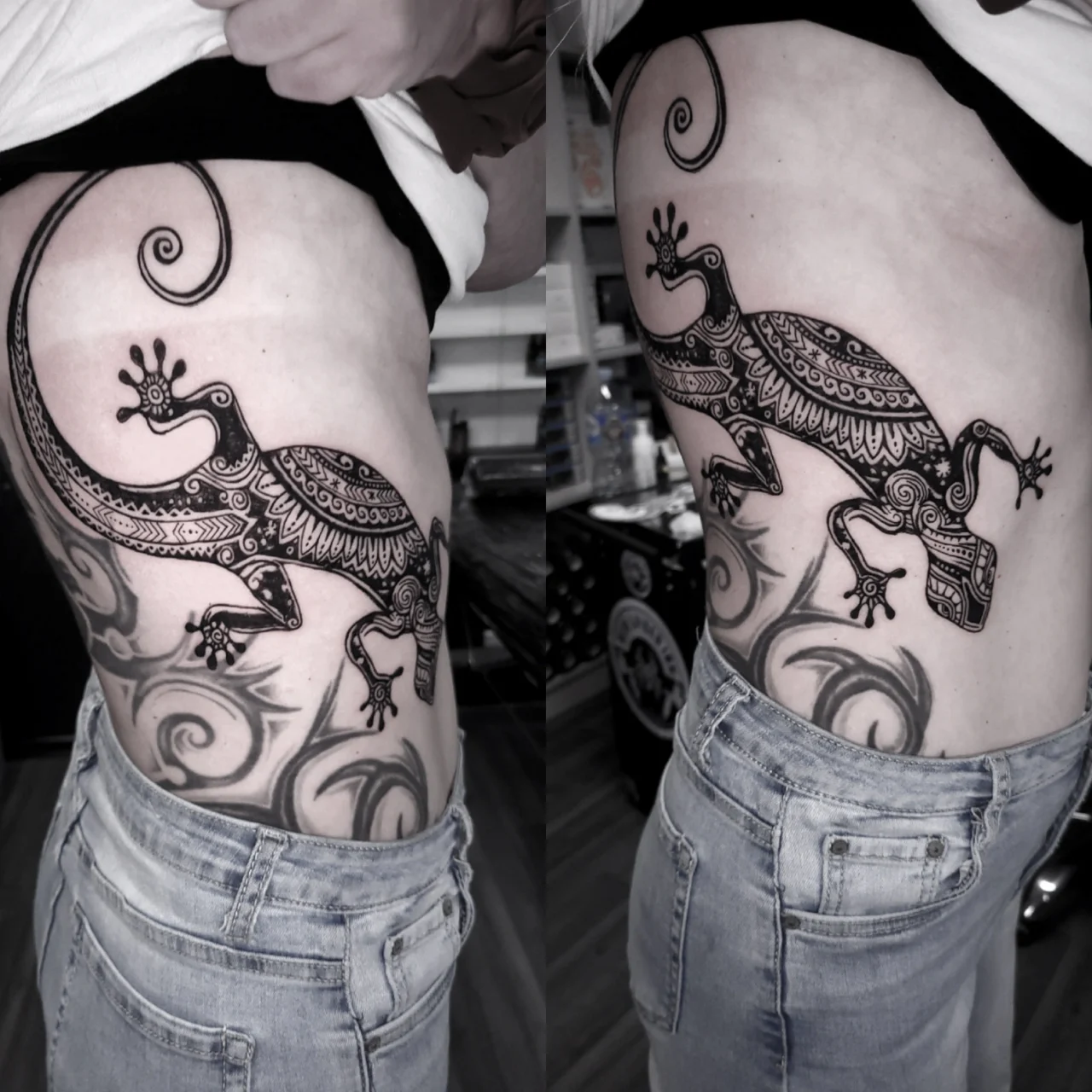 A large, detailed black-and-grey tattoo of a gecko with intricate patterns covers the side of a persons torso, extending from waist to chest. The person is wearing jeans and a lifted shirt to reveal the tattoo.