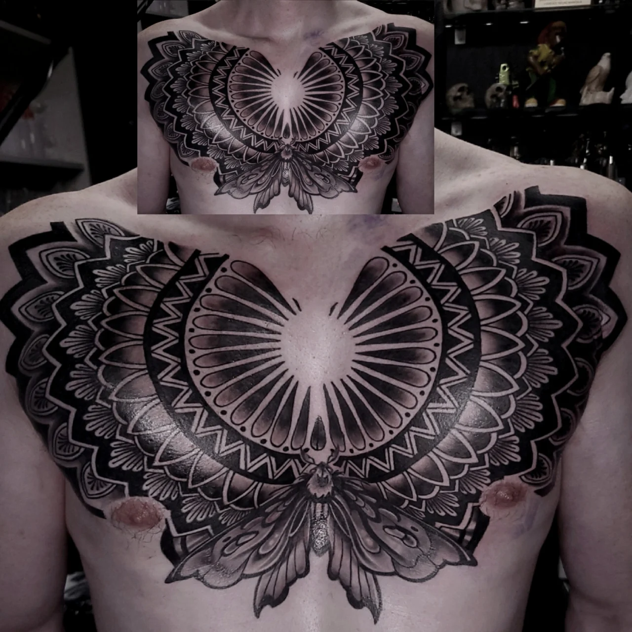 A person’s chest with a large, symmetrical black ink tattoo of a stylized moth with intricate, geometric wing patterns spanning across the chest and shoulders. An inset shows a close-up of the designs upper section.