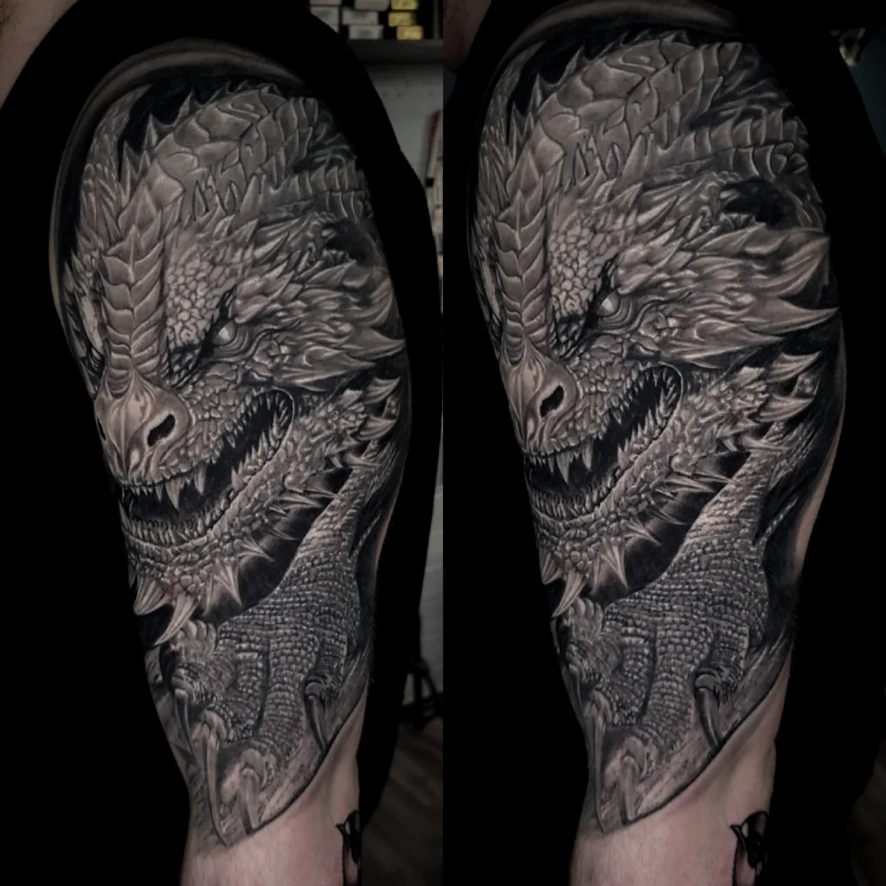 Black and grey tattoo on an upper arm depicting a detailed, fierce dragon head with open mouth, sharp teeth, and intricate scales, showcasing bold shading and lifelike texture.