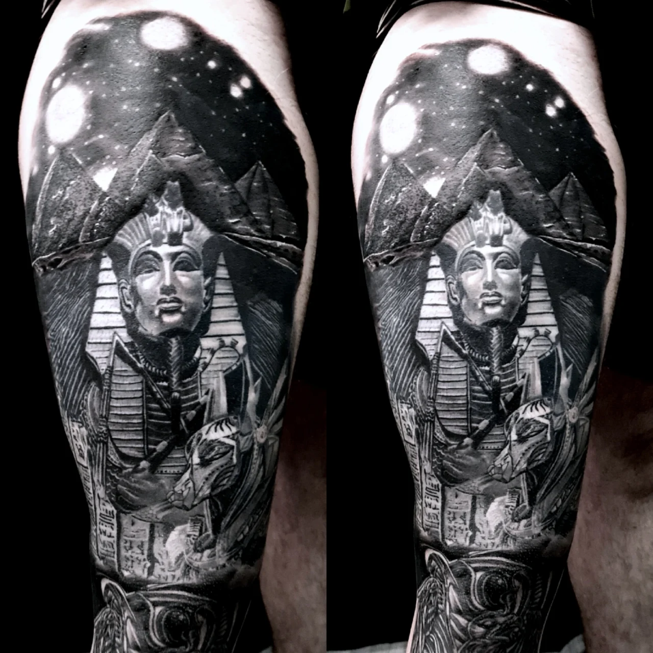 A detailed black and gray tattoo depicting the Egyptian Sphinx, pyramids, Anubis, and hieroglyphics, set against a night sky with bright glowing moons.