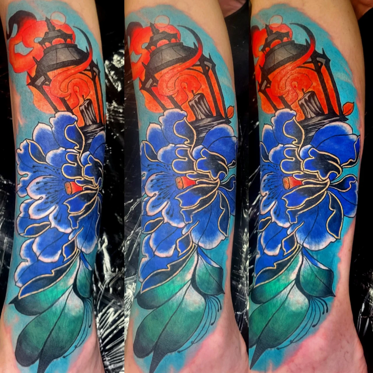 Tattoo featuring a glowing red and black lantern above a large blue flower with green leaves, outlined in gold and white, on a person’s skin. The tattoo is shown from three slightly different angles.
