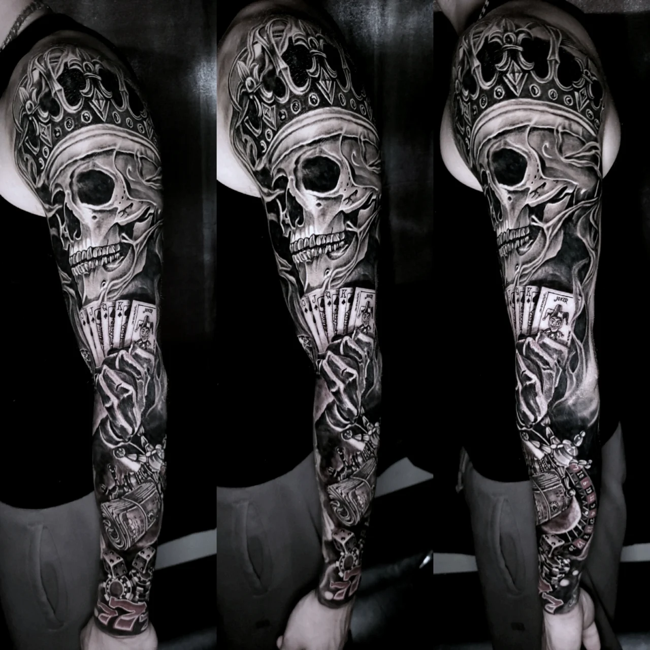 Tattoo sleeve featuring a crowned skull, playing cards, and intricate dark patterns, spanning the entire arm from shoulder to wrist. The design is detailed and predominantly black and grey.